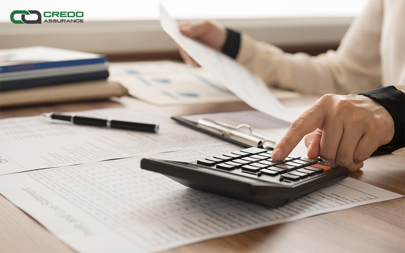 A man using a calculator for accounting purposes