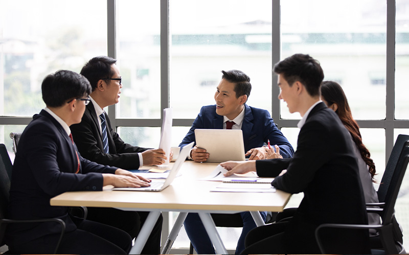 Corporate board members collaborating at a conference table.