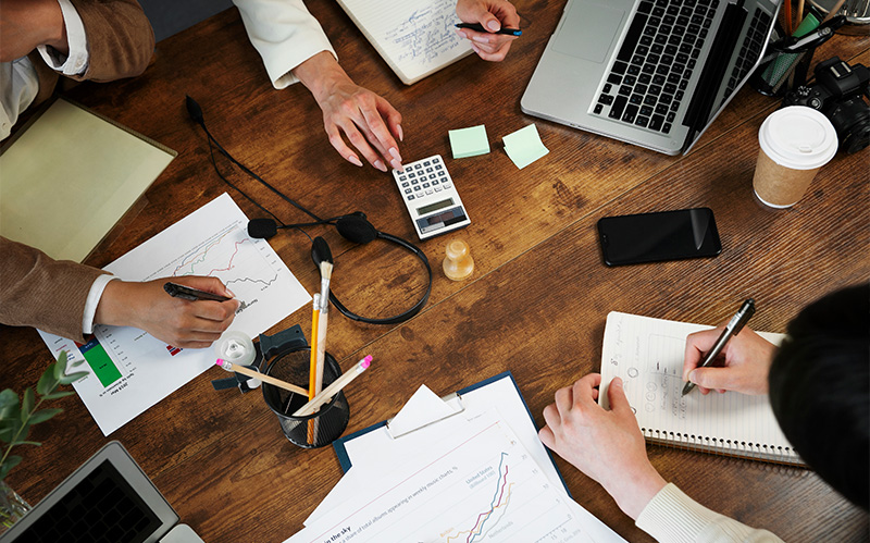 Corporate team analyzing financial charts and data