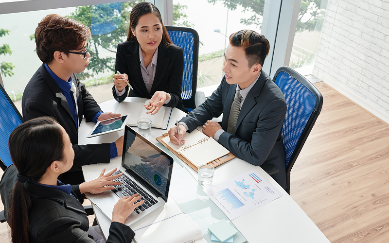 Corporate team analyzing ESG reporting data.
