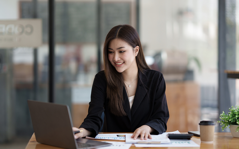 Professionals analyzing data metrics on laptop for ESG compliance