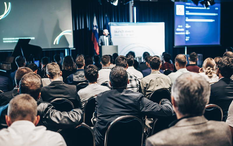 Business audience attending conference to differentiate CSR and ESG