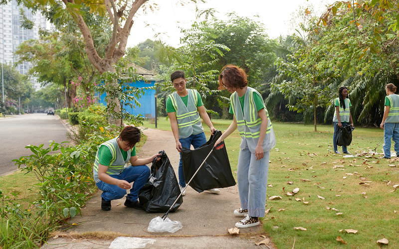 Volunteers gathering park litter as a business CSR initiative